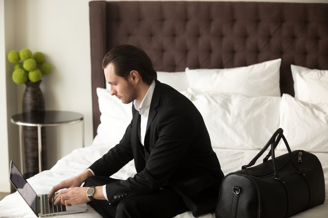 bigstock--188457985--business-man-working-from-hotel-while-travelling